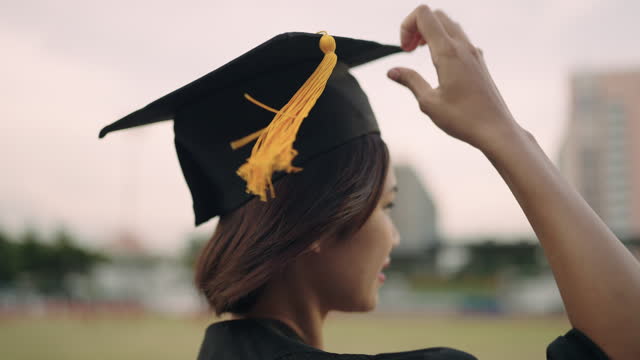 Graduation Congratulations student ceremony on the day of graduation at the university,Sunset Silhouette orange sky Slow motion 4K