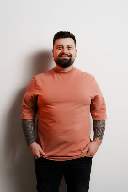 Positive plump man smiling at camera against white background