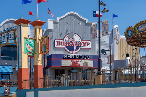Galveston, TX, USA - March 12, 2022: A Bubba Gump Shrimp Company restaurant at Pleasure Pier Amusement park in Galveston, TX, USA. Bubba Gump Shrimp Company is an American seafood restaurant chain.