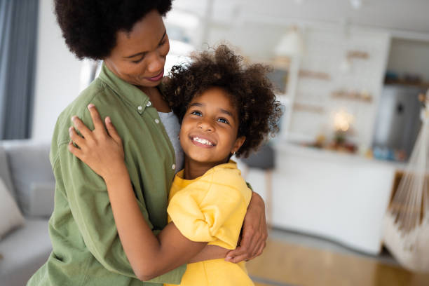 istock Young single mother looking at her daughter while hugging her 1614729827