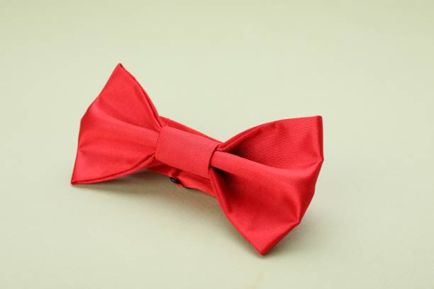 istock Stylish red bow tie on pale green background 1614756294