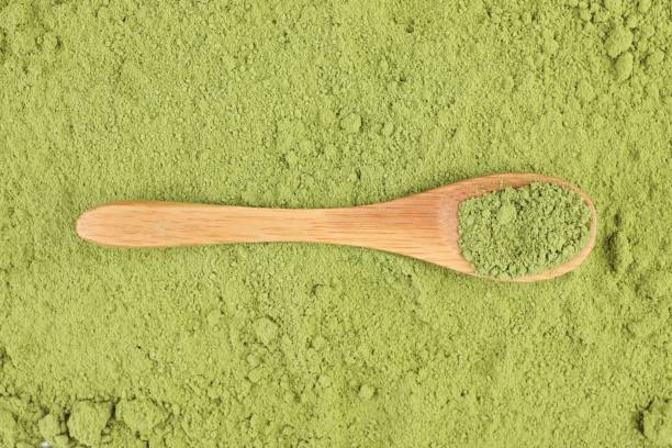 istock Wooden spoon on green matcha powder, top view 1614760109