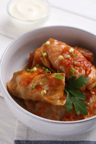istock Delicious stuffed cabbage rolls cooked with homemade tomato sauce on table, closeup 1614760133