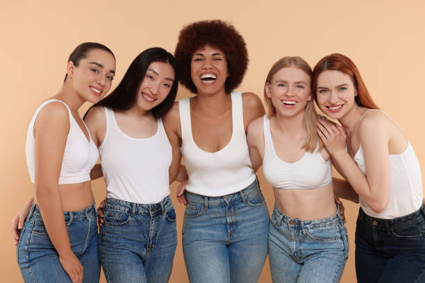 istock Group of beautiful young women on beige background 1614765501
