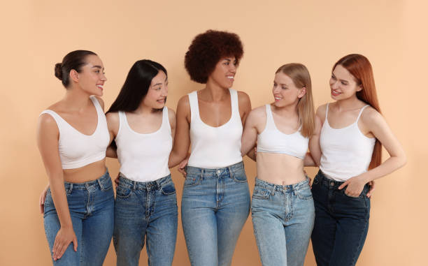 istock Group of beautiful young women on beige background 1614765526
