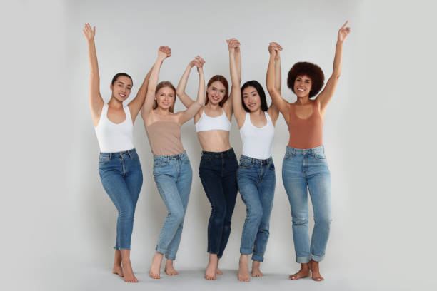 istock Group of beautiful young women on light grey background 1614767117