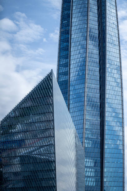 istock Modern office building close-up and blue sky, skyscraper facade 1614786456