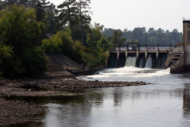 istock A dam with water flowing into a river. 1614790720