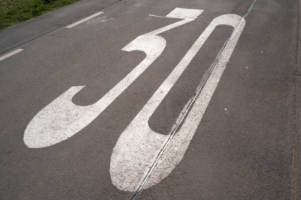 istock Painted 30 kilometers per hour for slow speed on a road 1614800335