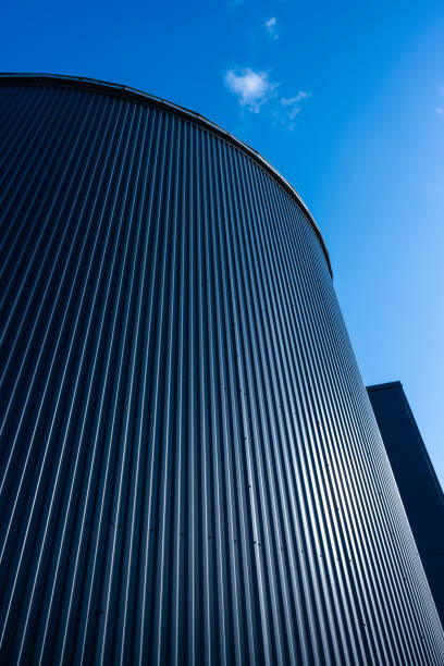 istock Large round grey tank on blue sky.. 1614818626