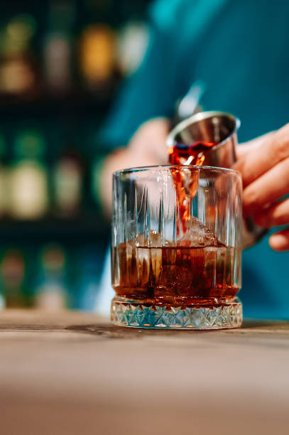 istock man bartender hand making negroni cocktail in bar 1614847550