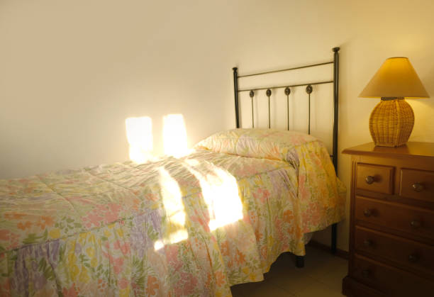 istock iron bed filled with bedspread, bright light from window, room on sunny morning, after good night sleep, Start your day in inviting and cozy room filled with gentle warmth of sunlight 1614850241