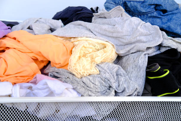 istock colorful clothes randomly lying around in mesh basket, mess, chaos in dressing room, decluttering closet, Promoting eco-friendly practices, such as recycling, upcycling and reducing waste in household 1614860855
