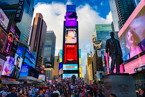 New York, New York, United States. August 07, 2023. Crowds of people of different nationalities circulate through Times Square with their LED screens on all sides.