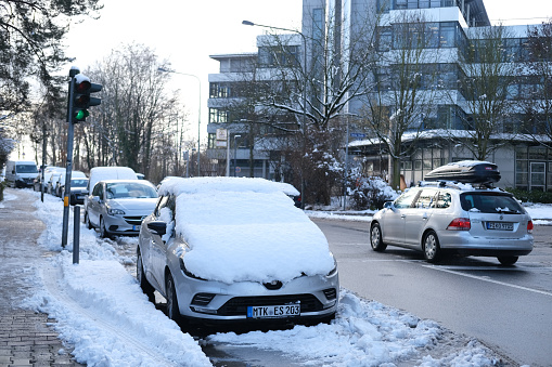 snowy Frankfurt street, snow covering windows and car bodies, heavy snow concept, Snow Blizzards, bad, Severe weather, urban environment in winter, change of seasons,