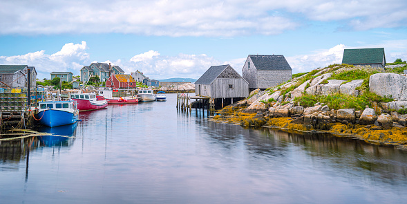 Peggy's Cove Seascape with moored boats and weathered seaside shacks in Nova Scotia, Canada