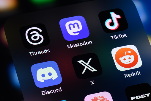 Toronto, Canada - August 4, 2023:  Popular social networking apps, including Threads, Mastodon, TikTok, Discord, X (formerly Twitter), Reddit and Post on an Apple iPhone.