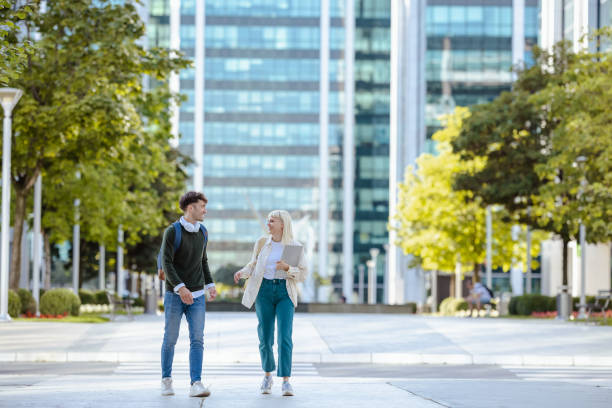 istock Cheerful students hanging out in the city 1614970863