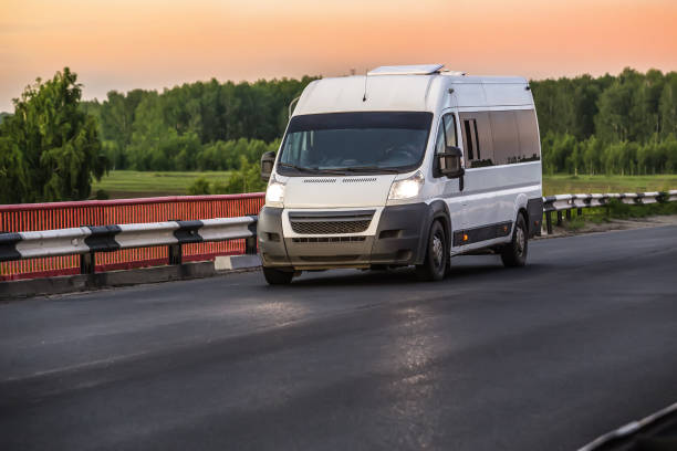 istock Minibus moves on a country road 1614978877
