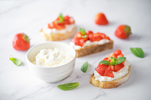 Strawberry ricotta sandwiches with mint leaves. toning. selective focus