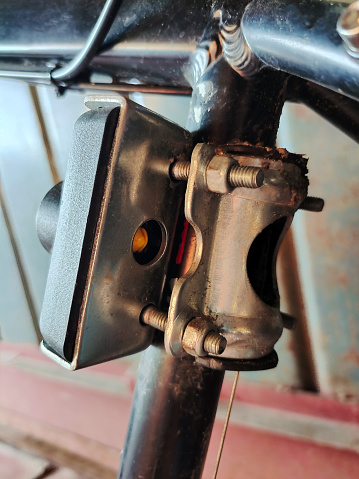 A close-up of part of the anti-theft mechanism on a bicycle frame. The background is blurred