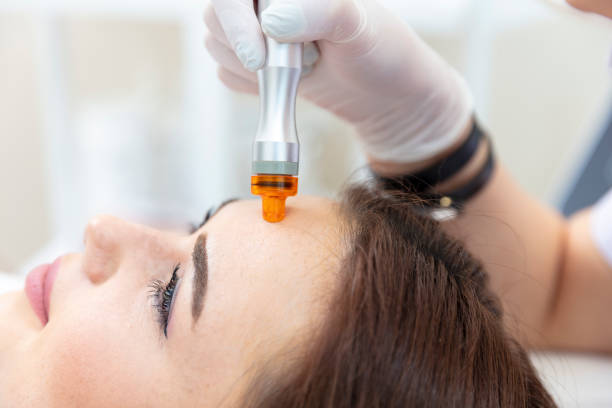 istock Beautician doing skin care for patient's face. 1614996762