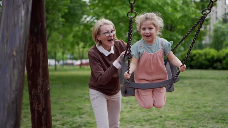 Little girl swinging in park