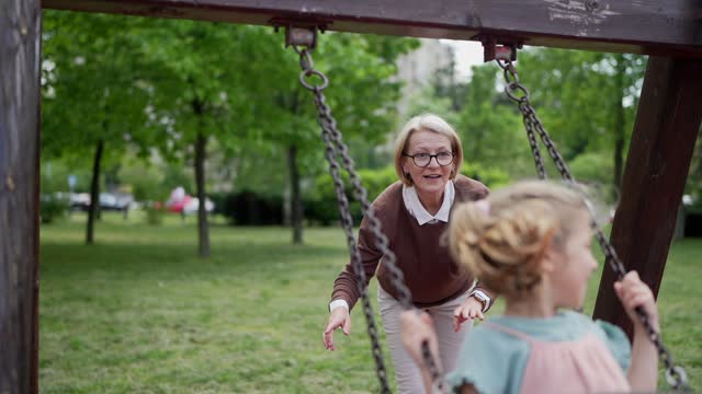 Little girl swinging in park