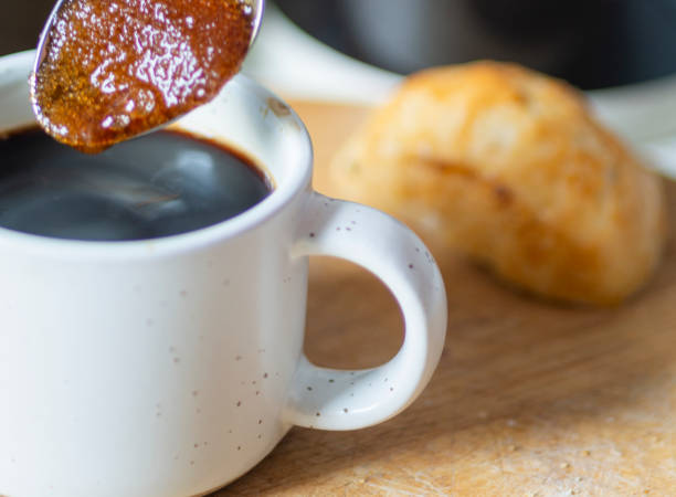 istock Demerara sugar in a silver teaspoon, absorbing hot espresso coffee from a small cup,in a domestic kitchen,Worcestershire,United Kingdom. 1615049636