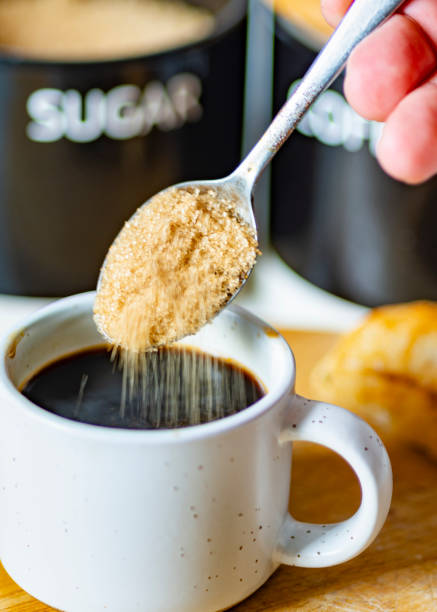 istock Demerara sugar falling from a silver teaspoon into a small cup of hot espresso coffee,in a domestic kitchen,Worcestershire,United Kingdom. 1615049995