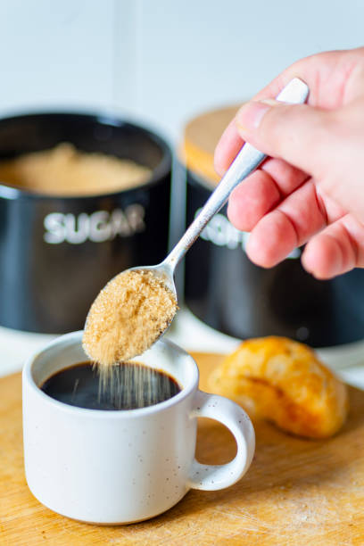 istock Demerara sugar falling from a silver teaspoon into a small cup of hot espresso coffee,in a domestic kitchen,Worcestershire,United Kingdom. 1615050154