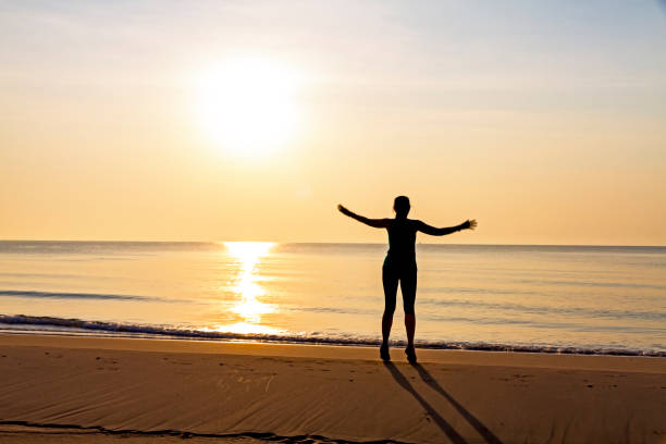 istock Woman exercise with sunrise at beach Bang Boet 1615085457