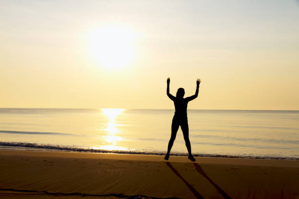 istock Woman exercise with sunrise at beach Bang Boet 1615085459