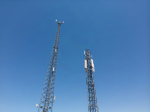Mobile communication tower in a blue sky background.