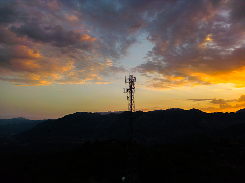 Mobile tower and sunset scene.