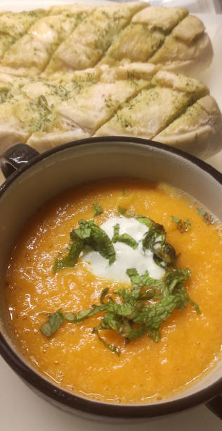 istock Pumpkin cream with goat cheese and garlic bread 1615126273