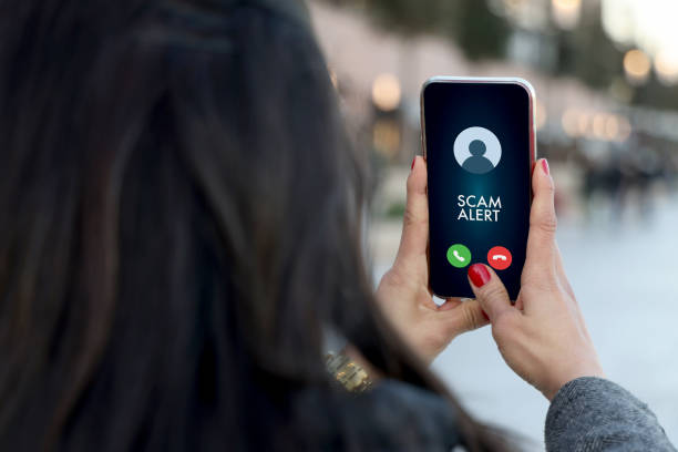 Scam alert on mobile phone screen Scam incoming call alert screen on mobile phone. suspicious message stock pictures, royalty-free photos & images