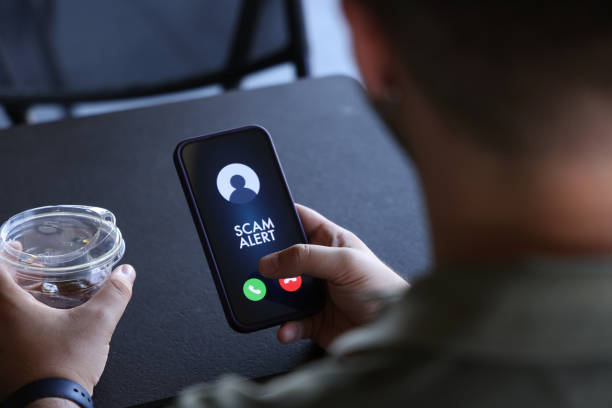 Scam alert on mobile phone screen Scam incoming call alert screen on mobile phone. suspicious message stock pictures, royalty-free photos & images