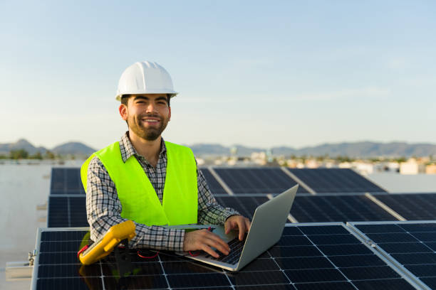 istock Smiling engineer with a laptop working with solar panels 1615146986