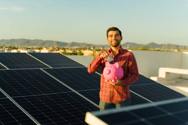 istock Attractive smiling man happy about financial liberty using solar panels 1615149257