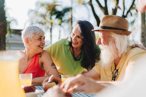istock Senior friends talking during picnic in a public park 1615162986