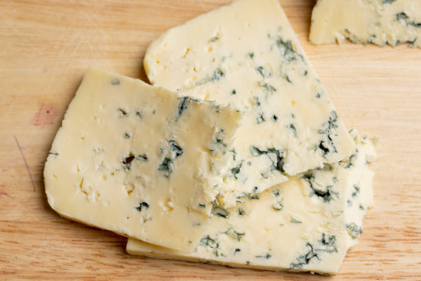 istock Cheese with blue mold cut into pieces 1615194636