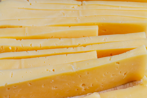fresh hard yellow cheese, fresh cheese with holes cut into chunks