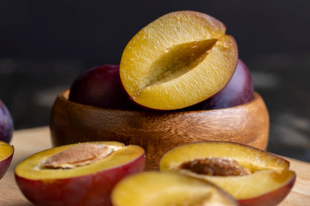 istock Ripe plums cut into pieces during cooking 1615197499