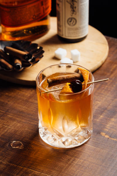 istock Alcoholic Old Fashioned Cocktail classic Bourbon Whiskey, sugar cube and aromatic bitters garnish with orange peel and a cherry 1615244117