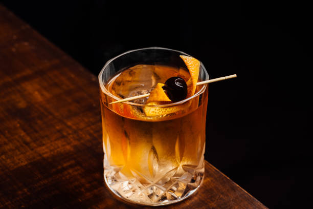 istock Alcoholic Old Fashioned Cocktail classic Bourbon Whiskey, sugar cube and aromatic bitters garnish with orange peel and a cherry 1615244625