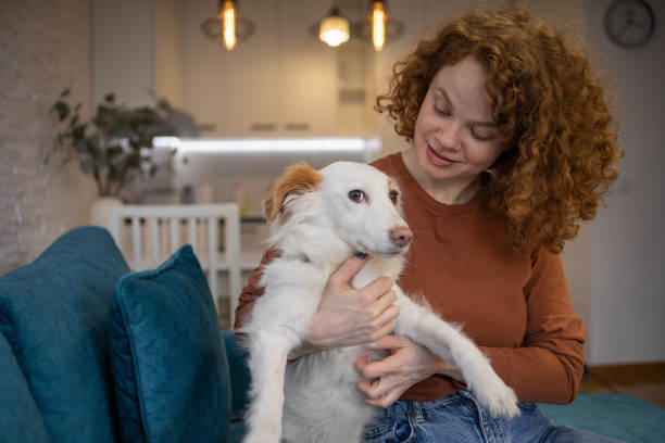 istock Young girl is enjoying with her dog 1615283233