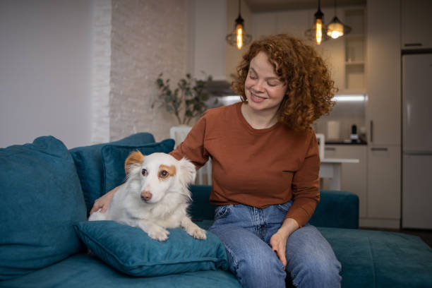 istock Young girl is enjoying with her dog 1615283234