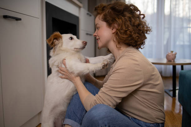 istock Young girl is enjoying with her dog 1615283243