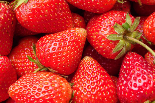 istock Fresh organic red strawberry fruit background 1615286927